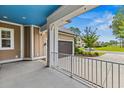 Covered porch view showcasing the blue ceiling and the attached garage at 496 Starlit Way, Myrtle Beach, SC 29579