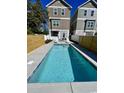 Inviting in-ground swimming pool surrounded by a concrete deck and privacy fence at 505 Chester St 5Th Ave. N, Myrtle Beach, SC 29577