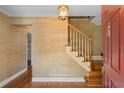 Inviting foyer featuring hardwood floors, a wooden staircase, and decorative wall coverings at 571 Fernwood Rd., Murrells Inlet, SC 29576