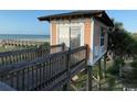 Elevated beach house featuring a charming wooden walkway leading to ocean views and private beach access at 5732 N Ocean Blvd., Myrtle Beach, SC 29577