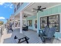 Spacious porch with ceiling fans, outdoor seating, and a picnic table at 6001 - 1195 S Kings Hwy., Myrtle Beach, SC 29575
