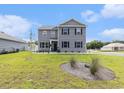 Charming two-story home with gray siding, black shutters and manicured front yard at 651 Choctaw Dr., Conway, SC 29526