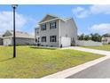 Charming two-story home with gray siding, black shutters and manicured front yard with garage at 651 Choctaw Dr., Conway, SC 29526