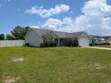 Well maintained home with vinyl siding, mature shrubs, and a spacious front yard at 671 American Beech St., Loris, SC 29569