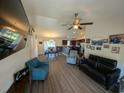 Open concept living room featuring wood floors and views of the dining area and kitchen at 671 American Beech St., Loris, SC 29569
