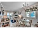 Cozy living room featuring a glass dining table with chairs and stunning ocean views from the balcony at 720 N Waccamaw Dr. # 205, Garden City Beach, SC 29576