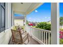 Cozy front porch seating featuring rocking chairs, a view of the neighborhood, and ample natural light at 908 Ashbourn Ct., Murrells Inlet, SC 29576