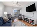 Cozy living room has a wall mounted TV, two recliners and opens to a balcony at 9501 Shore Dr. # 135, Myrtle Beach, SC 29572