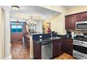 Well-equipped kitchen featuring stainless steel appliances, dark cabinets, and granite countertops at 100 North Beach Blvd. # 1816, North Myrtle Beach, SC 29582