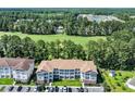 Aerial view of condo overlooking golf course and neighborhood, surrounded by lush greenery and serene landscapes at 125 South Shore Dr. # 204, Longs, SC 29568
