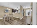 Cozy dining area featuring modern lighting, adjacent to the open kitchen with stainless steel appliances at 125 South Shore Dr. # 204, Longs, SC 29568