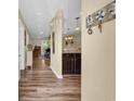 Inviting hallway with wood flooring, nautical decor, and partial view of the living room and kitchen at 125 South Shore Dr. # 204, Longs, SC 29568