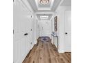 Inviting hallway with wood-look floors, decorative lighting, and closet space at 139 S Dunes Dr. # 304, Pawleys Island, SC 29585