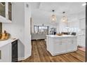 Modern kitchen with white cabinets, center island, stainless steel appliances, and open layout at 139 S Dunes Dr. # 304, Pawleys Island, SC 29585