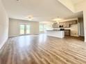 Open-concept living area with a ceiling fan and sliding glass doors connecting to the kitchen at 189 Norris Ln, Loris, SC 29569