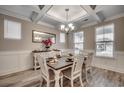 Elegant dining room featuring a coffered ceiling, stylish chandelier, and plenty of natural light at 2023 Singing Palm Loop, Little River, SC 29566