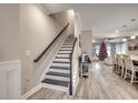 Elegant staircase with wood treads, leading to the upper level with open views of the living spaces at 2023 Singing Palm Loop, Little River, SC 29566
