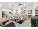 Spacious living room featuring high ceilings, large windows, and stylish furniture creating a cozy atmosphere at 212 Starlit Way, Myrtle Beach, SC 29579