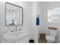 Stylish half bath with a pedestal sink, white shiplap, and wicker accents at 2308 Seaseeker Ln., Myrtle Beach, SC 29577