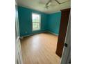 Bright bedroom featuring vibrant blue walls, wood floors, and a window at 232 Weyburn St., Myrtle Beach, SC 29579