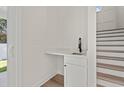 Hallway with a sink and white cabinets located under the stairs at 2426 Park St., North Myrtle Beach, SC 29582
