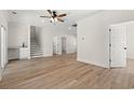 Spacious living room with wood-look flooring, ceiling fan, and stairway to the second floor at 2426 Park St., North Myrtle Beach, SC 29582