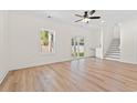 Bright living room with wood floors, staircase, and sliding glass doors that lead to the backyard at 2428 Park St., North Myrtle Beach, SC 29582