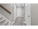 Hallway featuring wood-look floors, a staircase, and neutral wall paint at 3217 Shadow Pine Ct., Myrtle Beach, SC 29579
