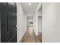Bright hallway with light wood-look floors leading to the living area and bedrooms at 326 Picnic Basket Pl., Longs, SC 29568