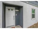 Exterior shot of the white front door of unit #5 with door sign, keypad entry and window at 403 71St Ave. N # 5, Myrtle Beach, SC 29572