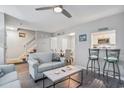 Cozy living room with plush sofas, stairway, and an adjacent dining area and kitchen at 403 71St Ave. N # 5, Myrtle Beach, SC 29572
