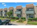 Charming townhouse with brick facade, blue trim, small balconies, and well-maintained landscaping at 4701 N Kings Hwy. # 8, Myrtle Beach, SC 29577