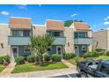 Charming townhouse with brick facade, blue trim, small balconies, and well-maintained landscaping at 4701 N Kings Hwy. # 8, Myrtle Beach, SC 29577