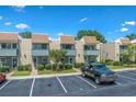 View of townhouses with brick facade, blue trim, balconies, parking spaces and landscaping at 4701 N Kings Hwy. # 8, Myrtle Beach, SC 29577
