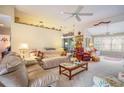 Spacious living room with neutral tones, ceiling fan, and multiple seating areas at 4726 Southern Trail, Myrtle Beach, SC 29579