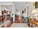 Spacious living room with hardwood floors, decorative columns and elegant archways at 487 Trestle Way, Conway, SC 29526