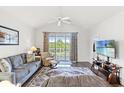 Comfortable living room with a ceiling fan, neutral colors, sliding door access to a balcony at 5801 Oyster Catcher Dr. # 431, North Myrtle Beach, SC 29582