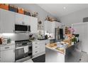 Modern kitchen featuring white cabinets and stainless steel appliances for a clean, sleek look at 709 Highway 90, Conway, SC 29526