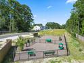 Community dog park with benches, play equipment, and a secure fence at 804 Nw Palm Frond Way # 804, Calabash, NC 28467