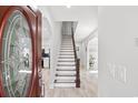 Bright foyer with hardwood floors, staircase, and an arched doorway to adjacent rooms at 867 Cardinal Pl., North Myrtle Beach, SC 29582