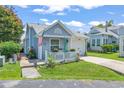 Cozy single-story home with light blue siding, well-manicured lawn, and inviting front porch with a white picket fence at 110 Cambridge Circle, Myrtle Beach, SC 29577