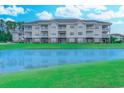 Exterior shot of condo building overlooking the lake at 110 South Shore Blvd. # 203, Longs, SC 29568