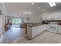 Bright kitchen open to living room with modern appliances and large window at 110 South Shore Blvd. # 203, Longs, SC 29568