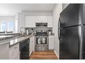 This kitchen includes granite countertops, stainless steel oven and plenty of storage with white cabinets and black refrigerator at 1100 Possum Trot Rd. # F218, North Myrtle Beach, SC 29582