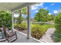 Inviting front porch view showcasing rocking chairs, lush landscaping, and a glimpse of the neighborhood at 1314 Prescott Circle, Myrtle Beach, SC 29577