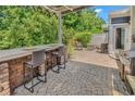 Well-appointed patio showcasing outdoor seating, a bar with chairs, a grill, and lush greenery at 1314 Prescott Circle, Myrtle Beach, SC 29577