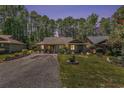 Charming single-story home featuring a well-manicured lawn and inviting curb appeal nestled amongst the trees at 137 Hickory Dr., Conway, SC 29526