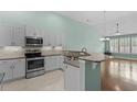 Modern kitchen with stainless steel appliances, granite countertops, tiled backsplash, and light wood floors at 156 Parmelee Dr. # D, Murrells Inlet, SC 29576