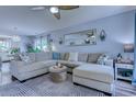 Bright living room features a comfortable sectional sofa, stylish rug, ceiling fan, and modern decor at 161 Barclay Dr., Myrtle Beach, SC 29579