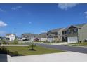 Street view of a neighborhood with well-maintained homes, manicured lawns, and paved roads at 161 Londonshire Dr., Myrtle Beach, SC 29579